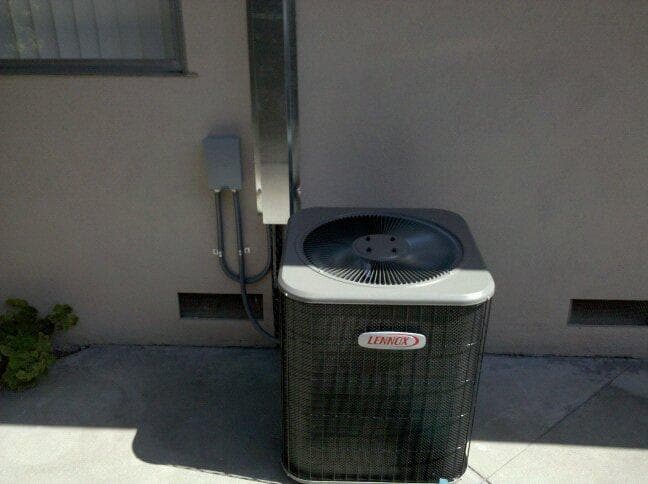 Residential air conditioning condenser unit serviced by Cal Climate Corp in Los Angeles